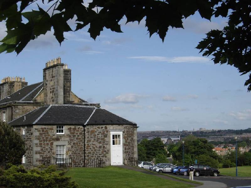 Beechwood House - Murrayfield in background.jpg - Side view of the school main building with one of the primary school classroms behind the white doors.  The art room was in the upper level behind the small white windows, formally Lord Bootby's bedroom. (see reunion photos for one taken inside the former artroom). In the background is Murrayfield Stadium. Was it always sunshine and blue skies when you were at school?